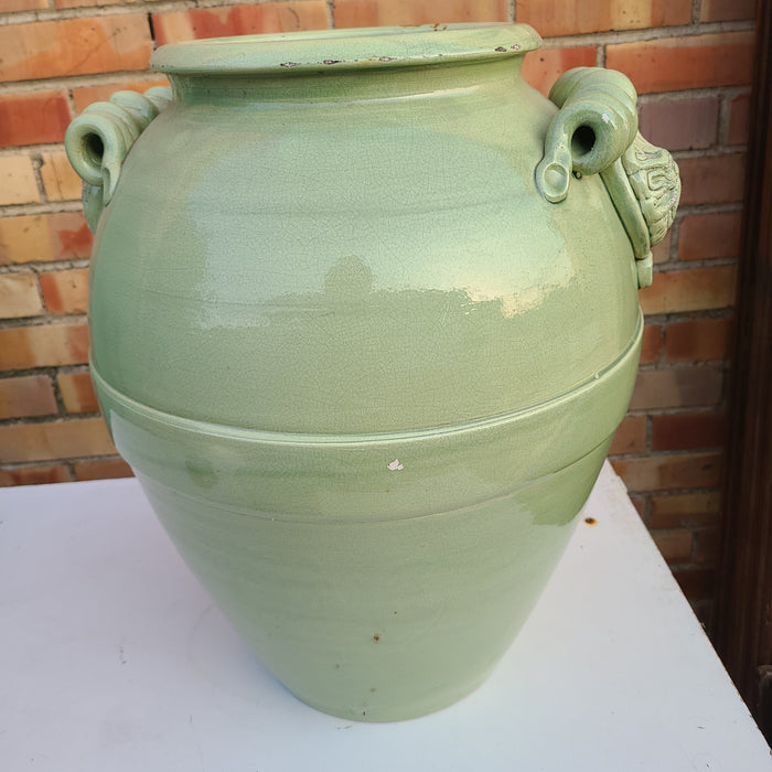 AS FOUND GREEN GLAZED POTTERY VASE WITH WIND FACES