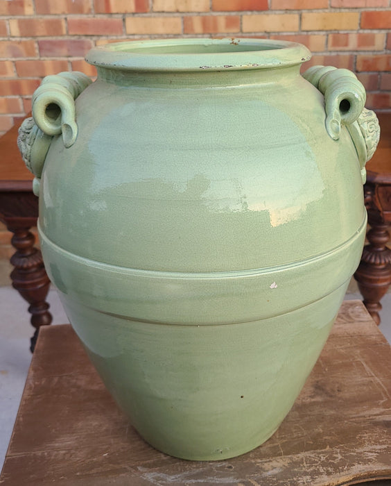 AS FOUND GREEN GLAZED POTTERY VASE WITH WIND FACES