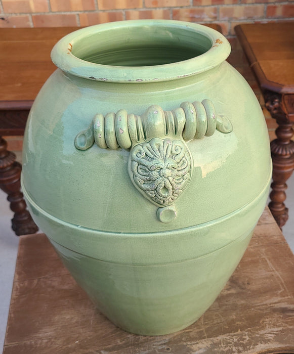 AS FOUND GREEN GLAZED POTTERY VASE WITH WIND FACES