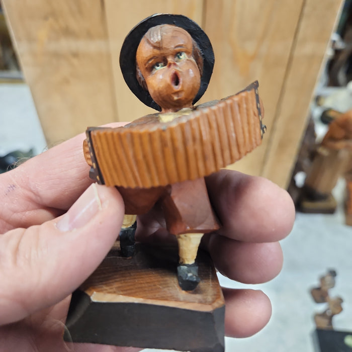 WOOD CARVING OF AN ACCORDIAN PLAYER BOY