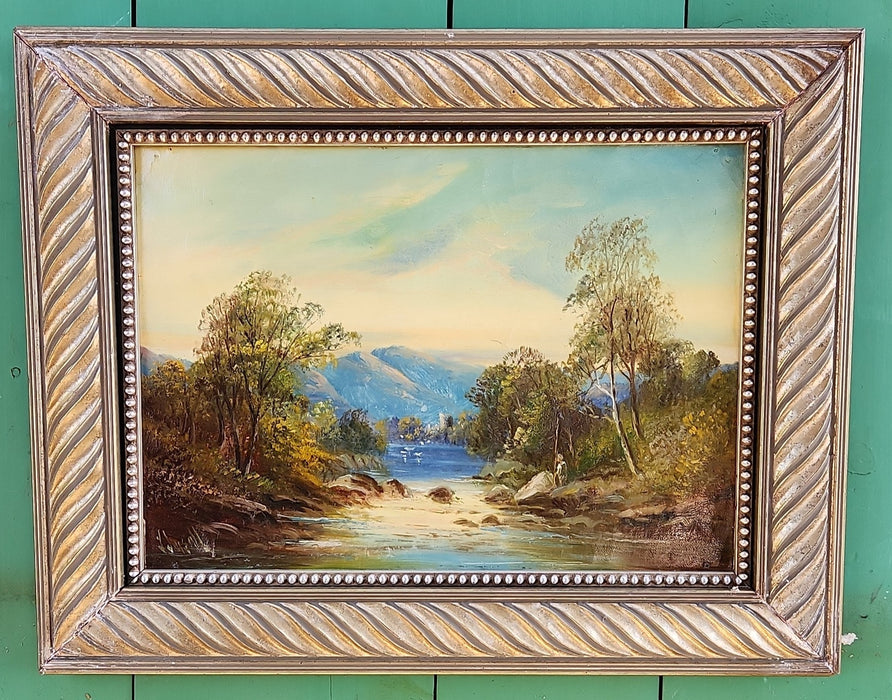 SILVER FRAMED OIL PAINTING OF A CASTLE BY A STREAM-SIGNED