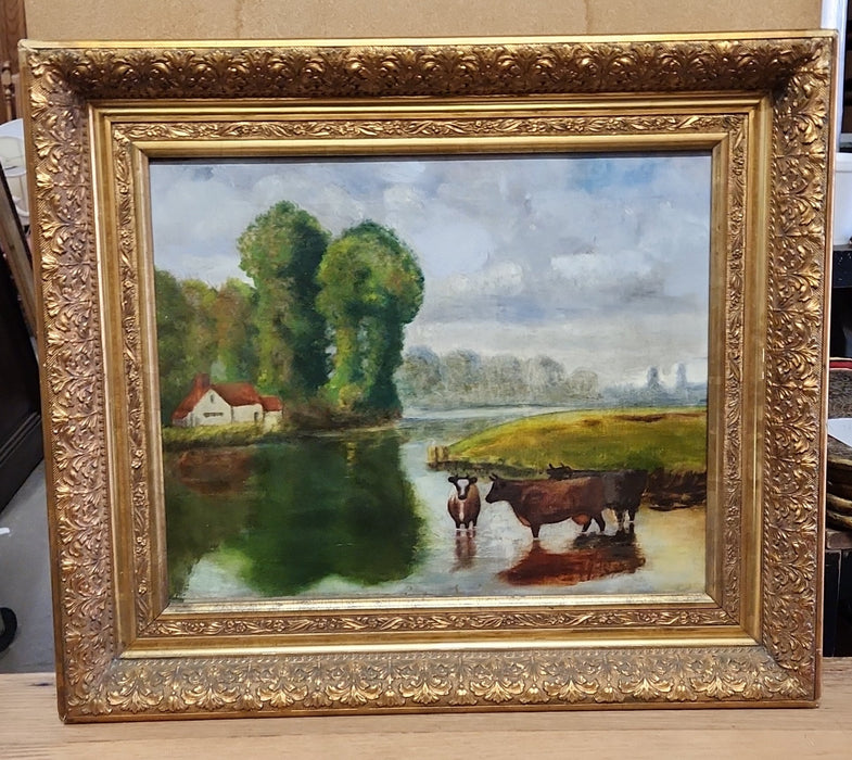 GOLD FRAMED OIL PAINTING OF COWS IN A RIVER BEND