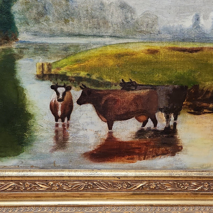 GOLD FRAMED OIL PAINTING OF COWS IN A RIVER BEND