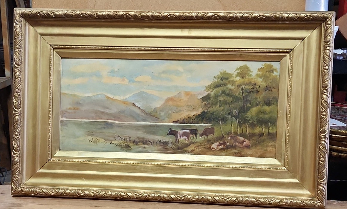 GOLD FRAMED OIL PAINTING OF COWS BY A MOUNTAIN LAKE ON MASONITE