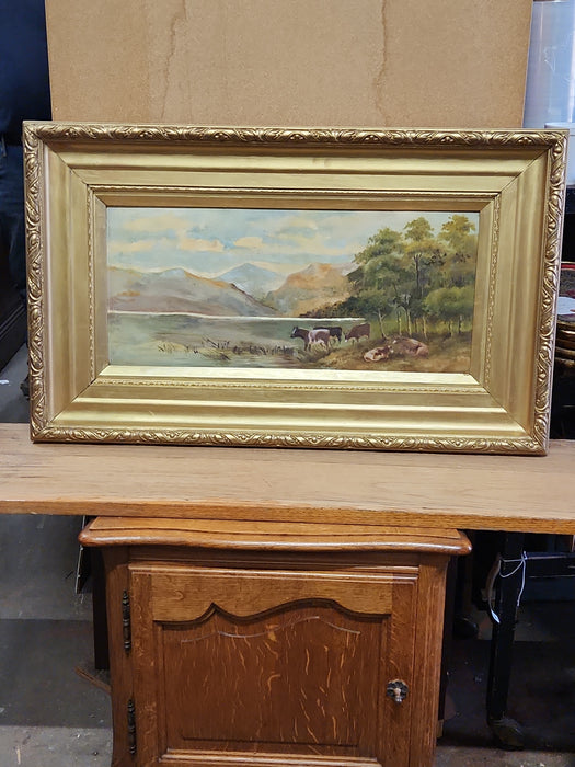 GOLD FRAMED OIL PAINTING OF COWS BY A MOUNTAIN LAKE ON MASONITE