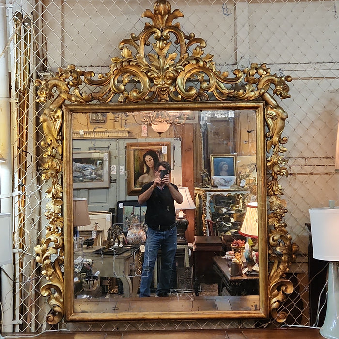 LARGE 19TH CENTURY GILT GESSO AND WOOD MIRROR WITH GRIFFINS AND MASK PEDIMENT