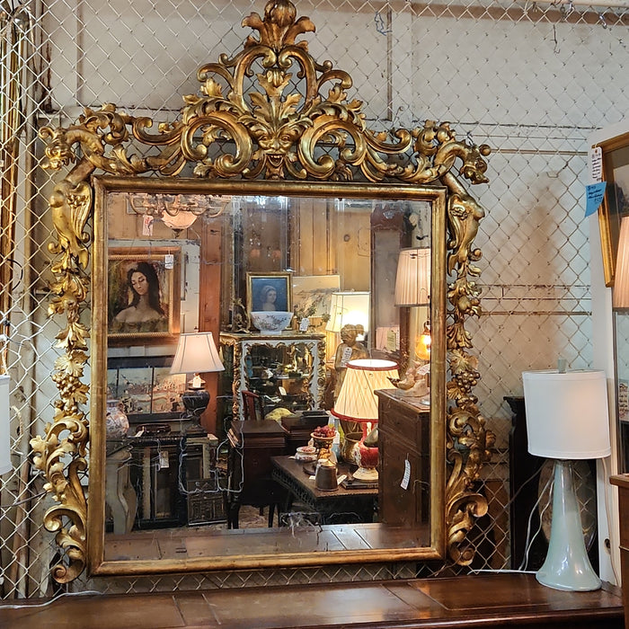 LARGE 19TH CENTURY GILT GESSO AND WOOD MIRROR WITH GRIFFINS AND MASK PEDIMENT