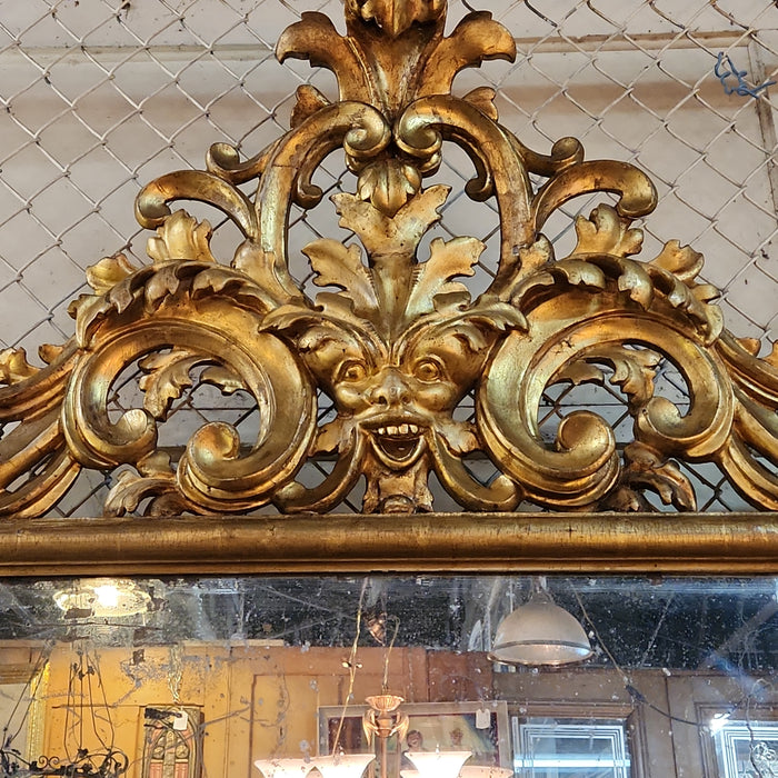 LARGE 19TH CENTURY GILT GESSO AND WOOD MIRROR WITH GRIFFINS AND MASK PEDIMENT