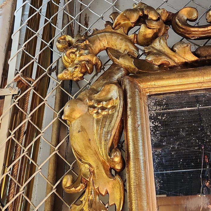 LARGE 19TH CENTURY GILT GESSO AND WOOD MIRROR WITH GRIFFINS AND MASK PEDIMENT