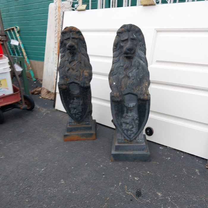 PAIR OF CAST IRON STANDING LIONS WITH SHIELDS