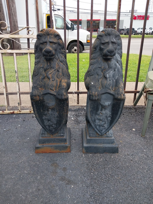 PAIR OF CAST IRON STANDING LIONS WITH SHIELDS