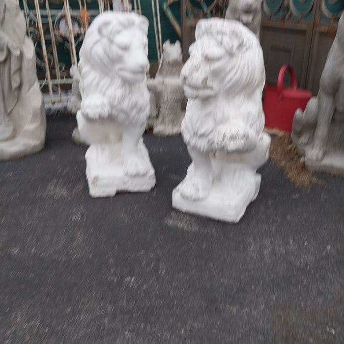 PAIR OF PAINTED CONCRETE LIONS WITH RAISED PAWS