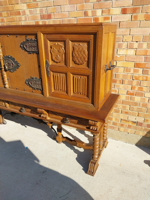 LONG OAK LINENFOLD CABINET WITH IRON STRETCHER AND HANDLES