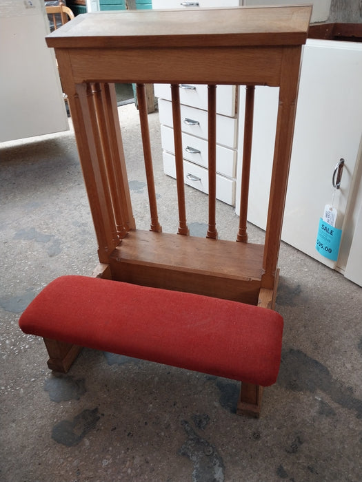 LARGE OAK KNEELER WITH SPINDLES AND RED CUSHION