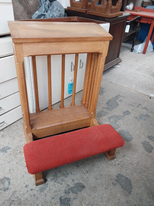 LARGE OAK KNEELER WITH SPINDLES AND RED CUSHION