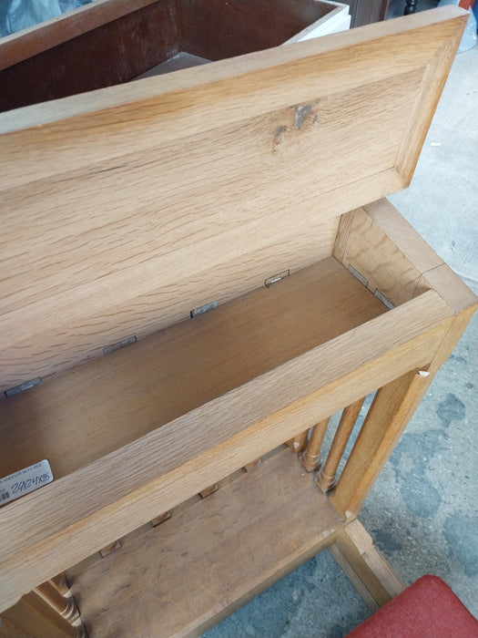 LARGE OAK KNEELER WITH SPINDLES AND RED CUSHION