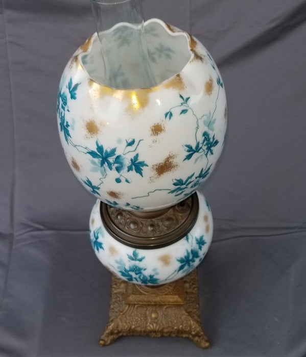 SMALL CONVERTED OIL LAMP WITH BLUE, YELLOW AND WHITE EGG SHAPED FLORAL SHADE