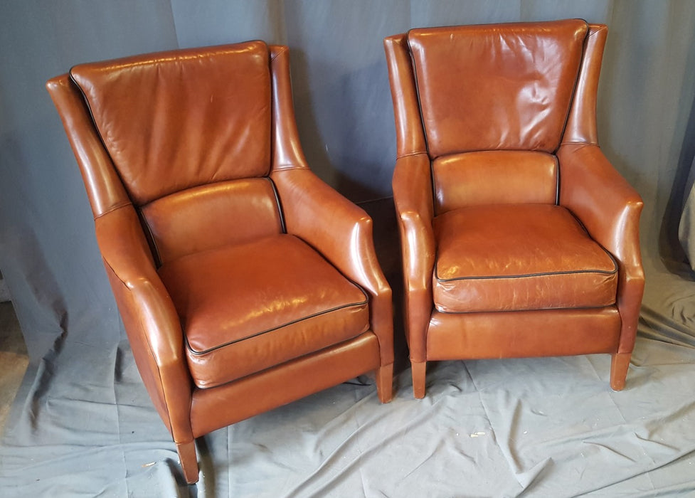 PAIR OF ENGLISH LEATHER CHAIRS AND OTTOMAN