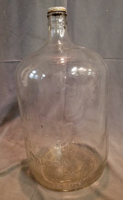 1930'S EMBOSSED OZARKA GLASS WATER BOTTLE IN ORIGINAL GRATE