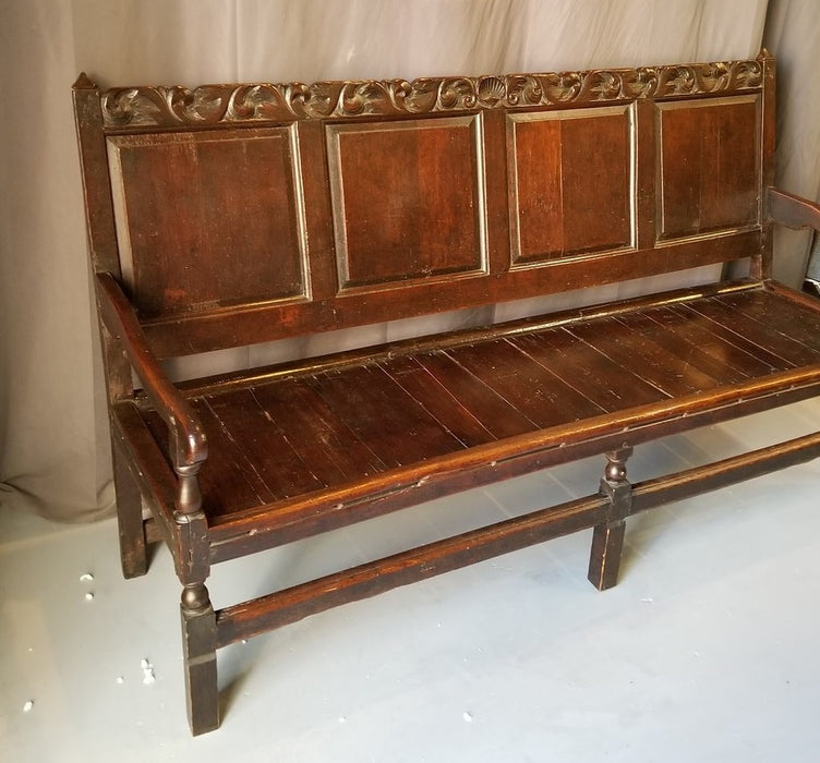 EARLY DARK OAK ENGLISH BENCH WITH ARMS AND A CARVED CREST RAIL