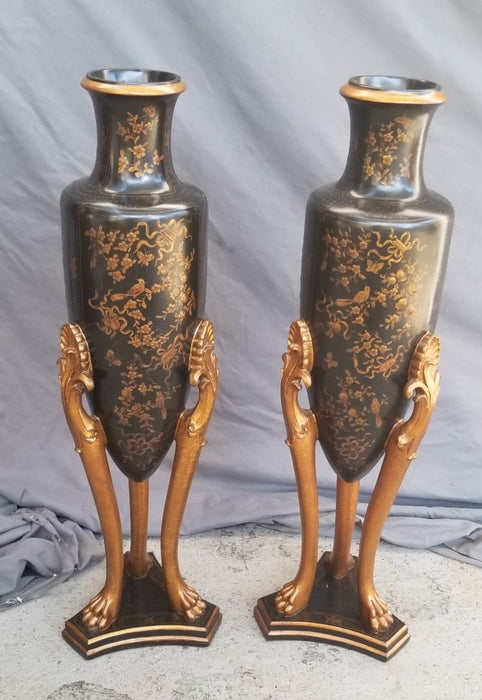 PAIR OF BLACK AND GOLD VASES ON LEGS - NOT OLD