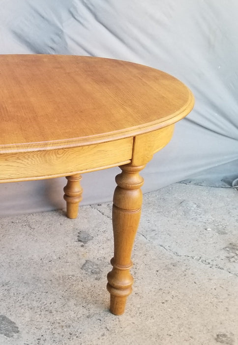 OAK OVAL DINING TABLE WITH TURNED LEGS AND POP UP LEAF