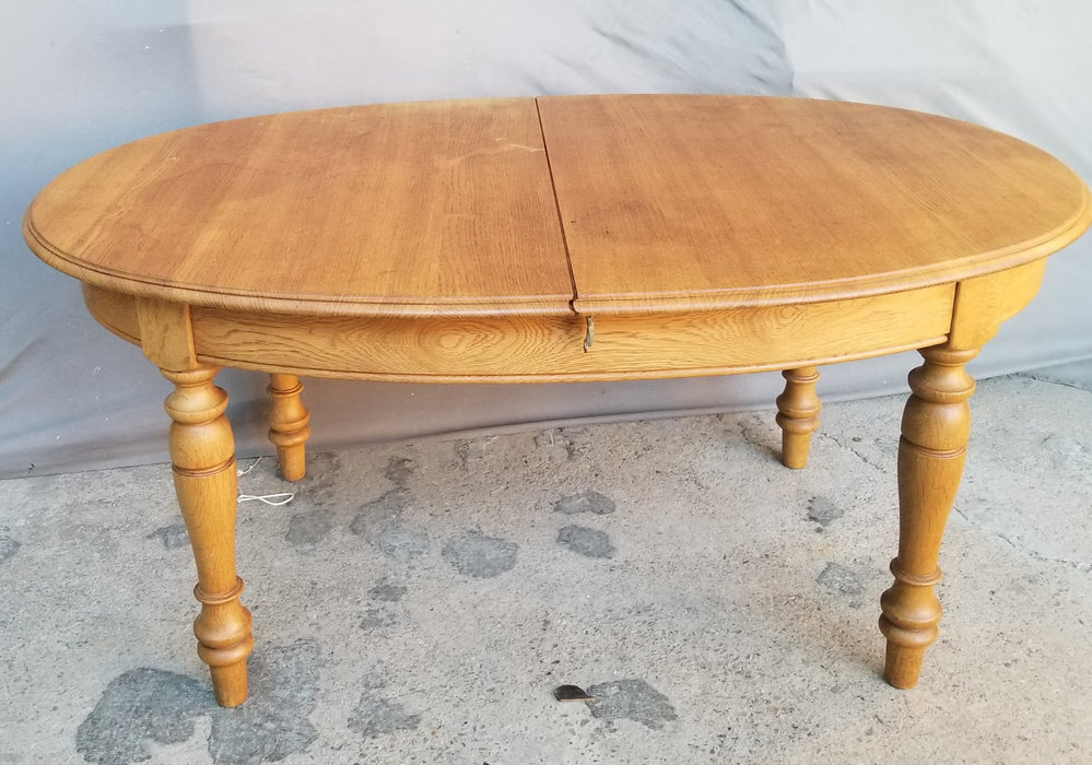 OAK OVAL DINING TABLE WITH TURNED LEGS AND POP UP LEAF