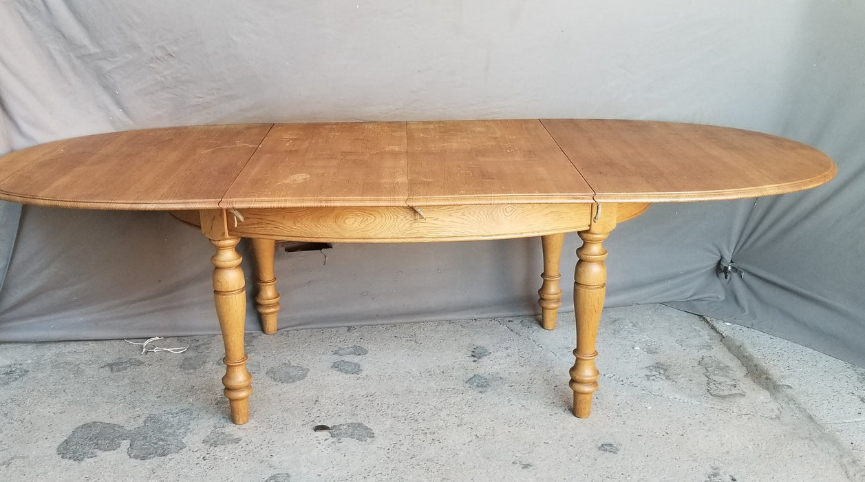 OAK OVAL DINING TABLE WITH TURNED LEGS AND POP UP LEAF