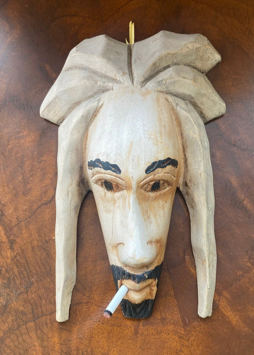 CARVED FACE OF A SMOKER