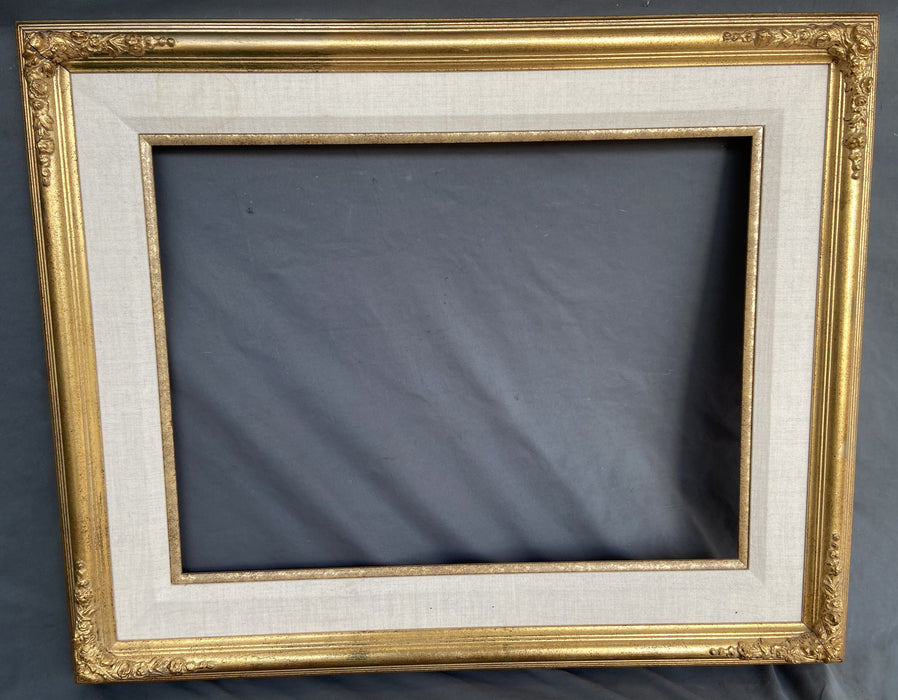 GOLD FRAME WITH ORNATE CORNERS AND LINEN LINER