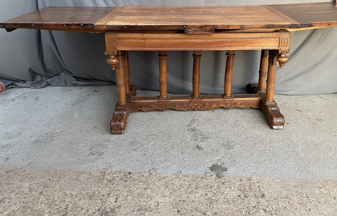 FRENCH RENAISSANCE REVIVAL WALNUT TABLE WITH COLUMN SUPPORTS AND SCROLL ACCENTS