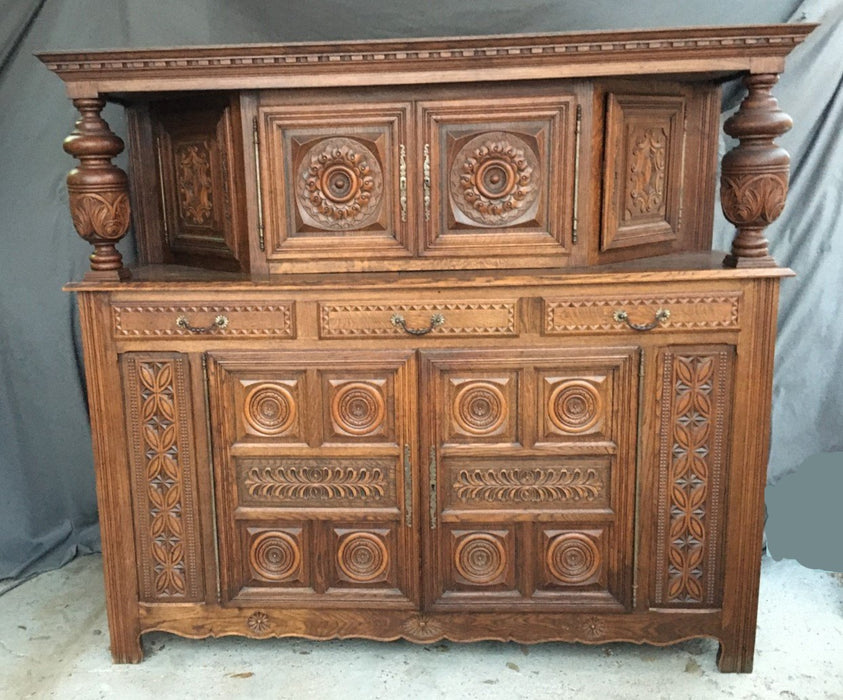 RENAISSANCE REVIVAL CARVED OAK COURT CUPBOARD WITH FOLIATE AND ROSETTE CARVED ACCENTS