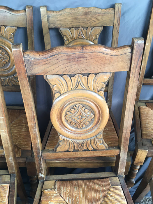 SET OF 6 NEO RENAISSANCE OAK CHAIRS WITH ROSETTE CARVED BACKS AND RUSH WOVEN SEATS