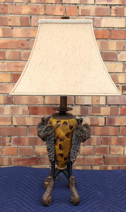 AMBER COLORED LAMP WITH ACANTHUS FEET AND RAM HEADS