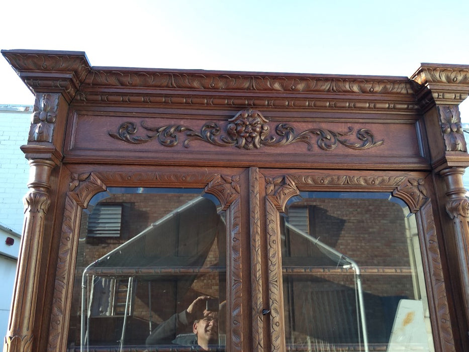 CARVED HUNTBOARD WITH LIONS, BIRDS AND BEVELED GLASS DOORS