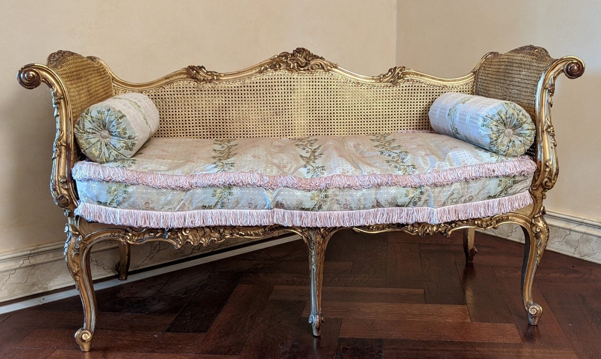 LOUIS XV CARVED GILTWOOD AND CANE SETTE