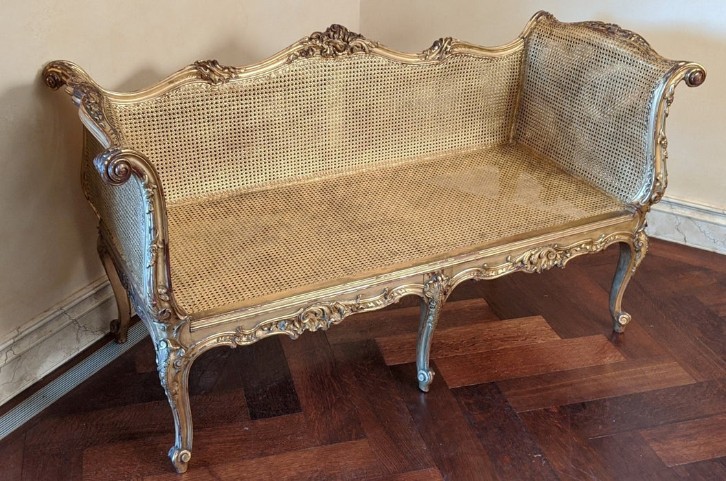 LOUIS XV CARVED GILTWOOD AND CANE SETTE