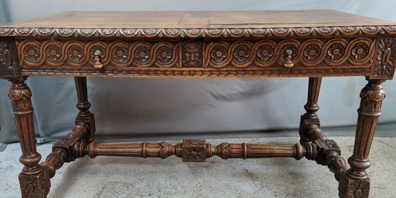 LARGE OAK LIBRARY TABLE WITH CARVED EVOLUTES