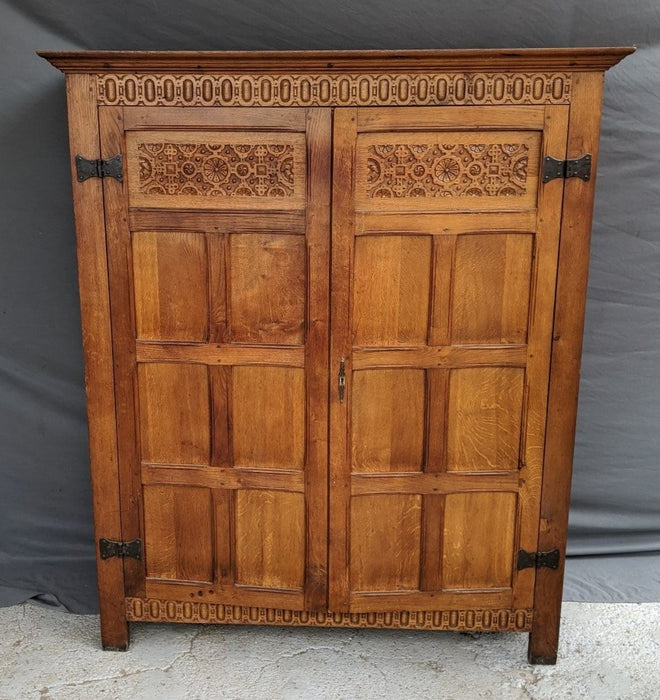 SMALL LIGHT OAK 2 DOOR CABINET W/ FLORETTES