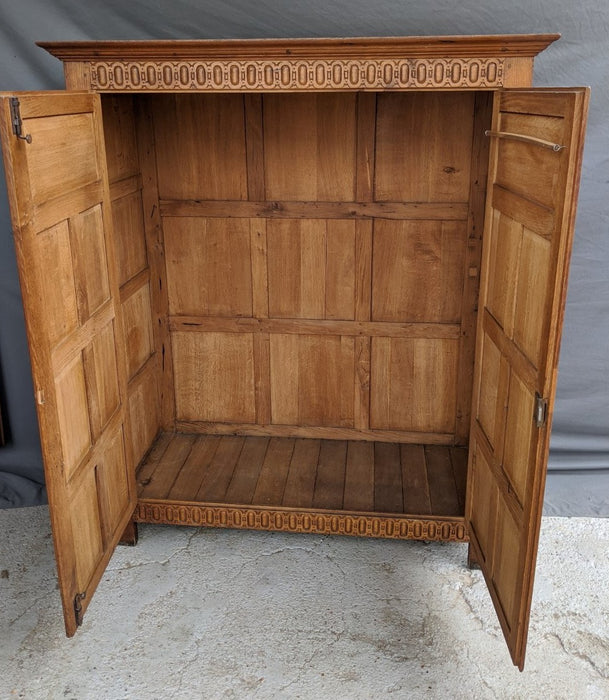 SMALL LIGHT OAK 2 DOOR CABINET W/ FLORETTES