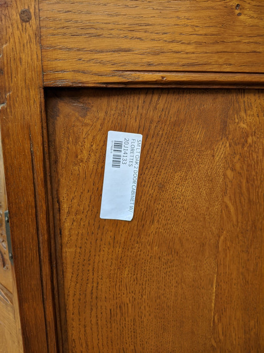 SMALL LIGHT OAK 2 DOOR CABINET W/ FLORETTES