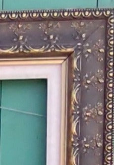 ORNATE GOLD FRAME WITH FLORAL MOTIF AND LINEN LINER