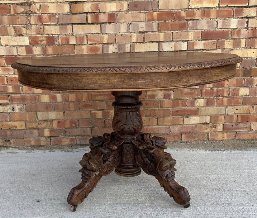 FRENCH OAK PEDESTAL TABLE WITH GRIFFINS