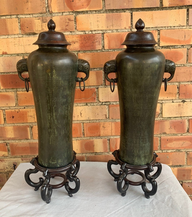 PAIR OF MAITLAND SMITH METAL URNS WITH WOOD BASES AND TOPS