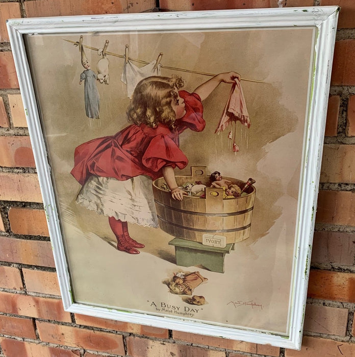 FRAMED PRINT OF GIRL WASHING CLOTHES AND TOYS