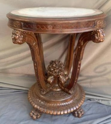 MAHAGONY OCCASIONAL TABLE WITH CARVED FACES AND FLOWERS