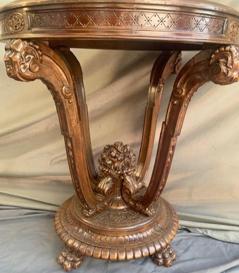 MAHAGONY OCCASIONAL TABLE WITH CARVED FACES AND FLOWERS