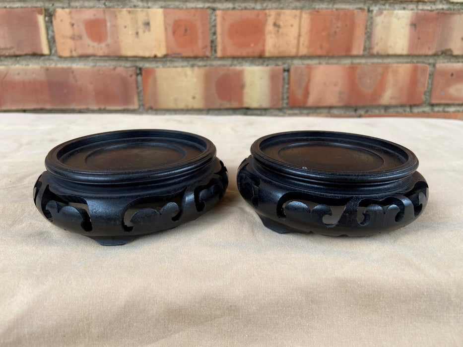 PAIR OF SMALL BLACK PIERCE CARVED ROUND ASIAN STANDS