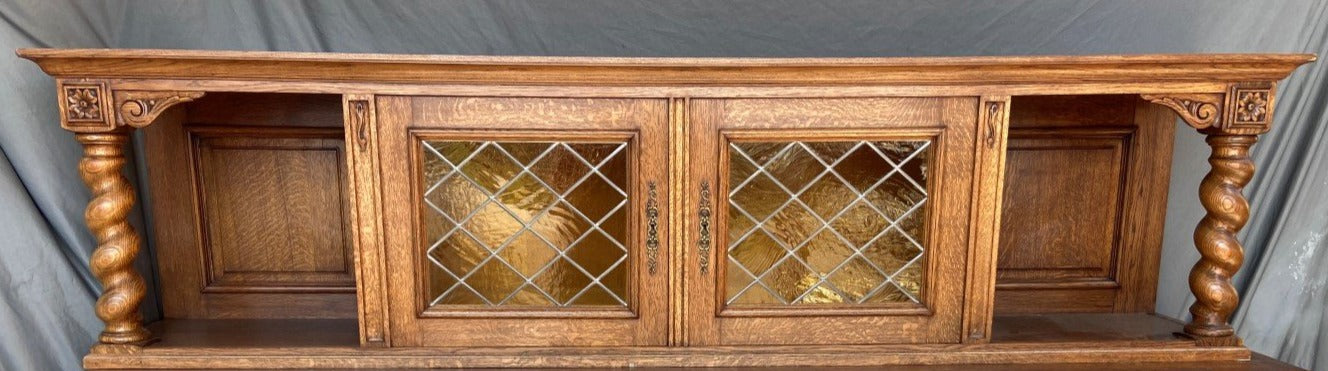 OAK CARVED BENCH WITH BARLEY TWIST COLUMNS AND LEADED GLASS