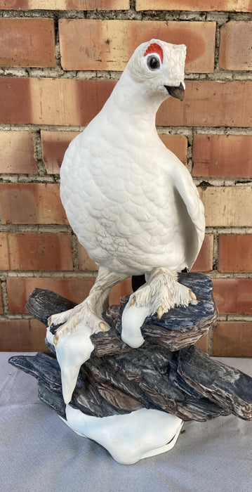 PAIR OF PORCELAIN ARCTIC BIRD STATUES ON ROCKS